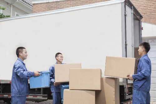 Professional movers handling furniture during a flat removal