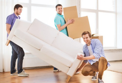 Crew loading separated recyclable materials and donated furniture before collection