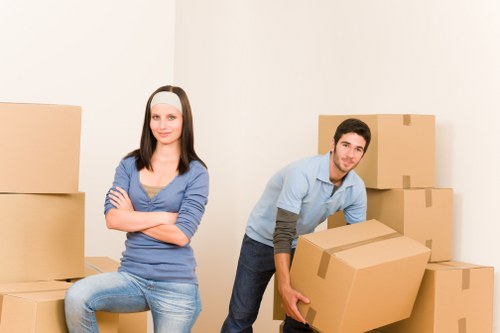 Professional movers handling furniture during a local home relocation