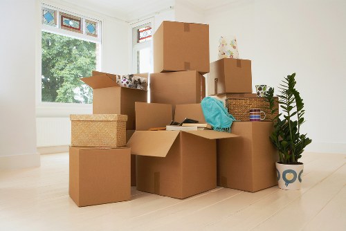 Professional movers handling furniture carefully in a local property