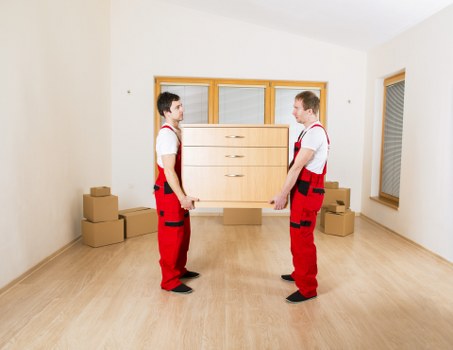 Professional movers handling furniture and boxes in Grahame Park